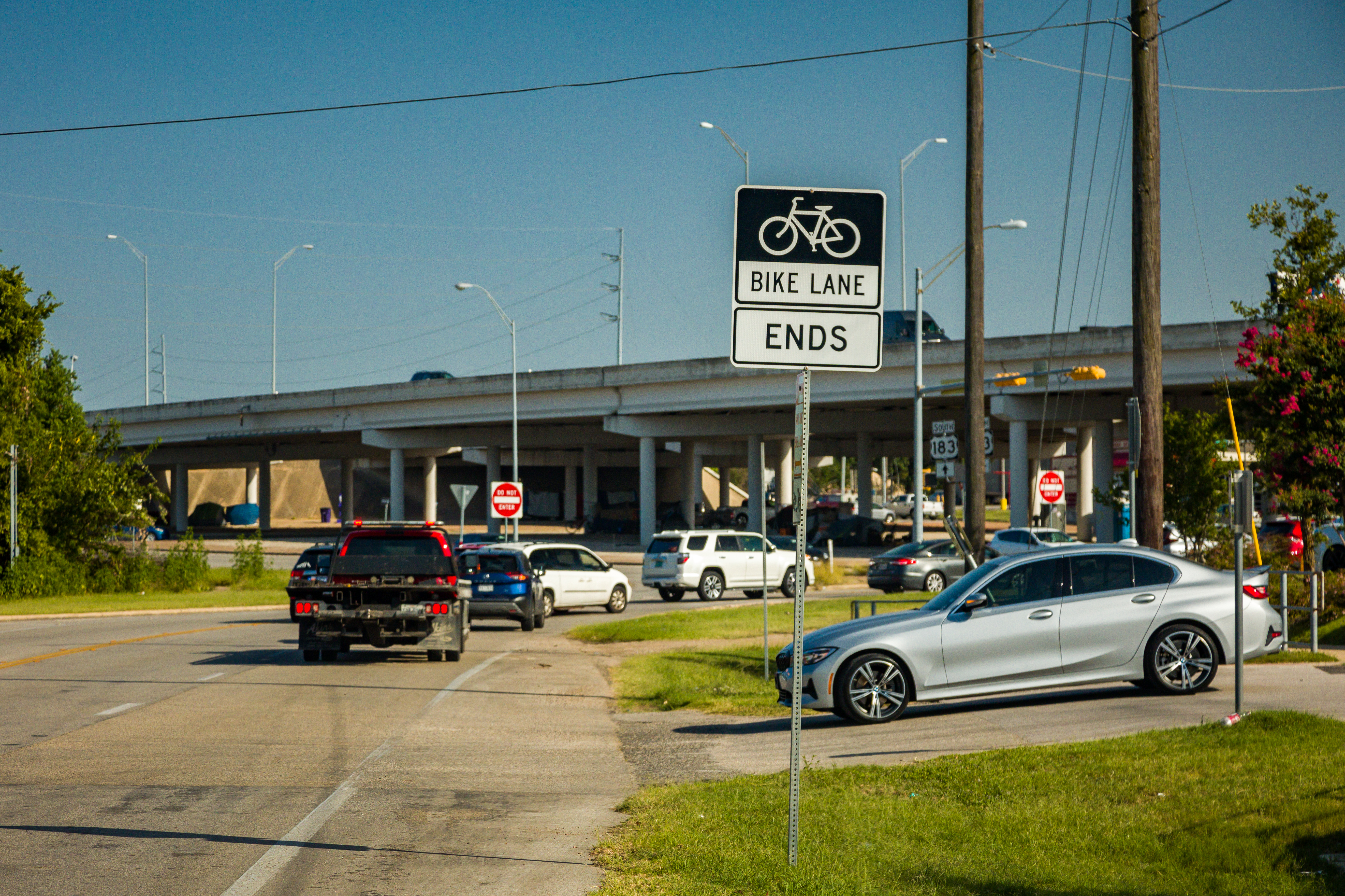 Vehicles driving near a roadside sign reading 