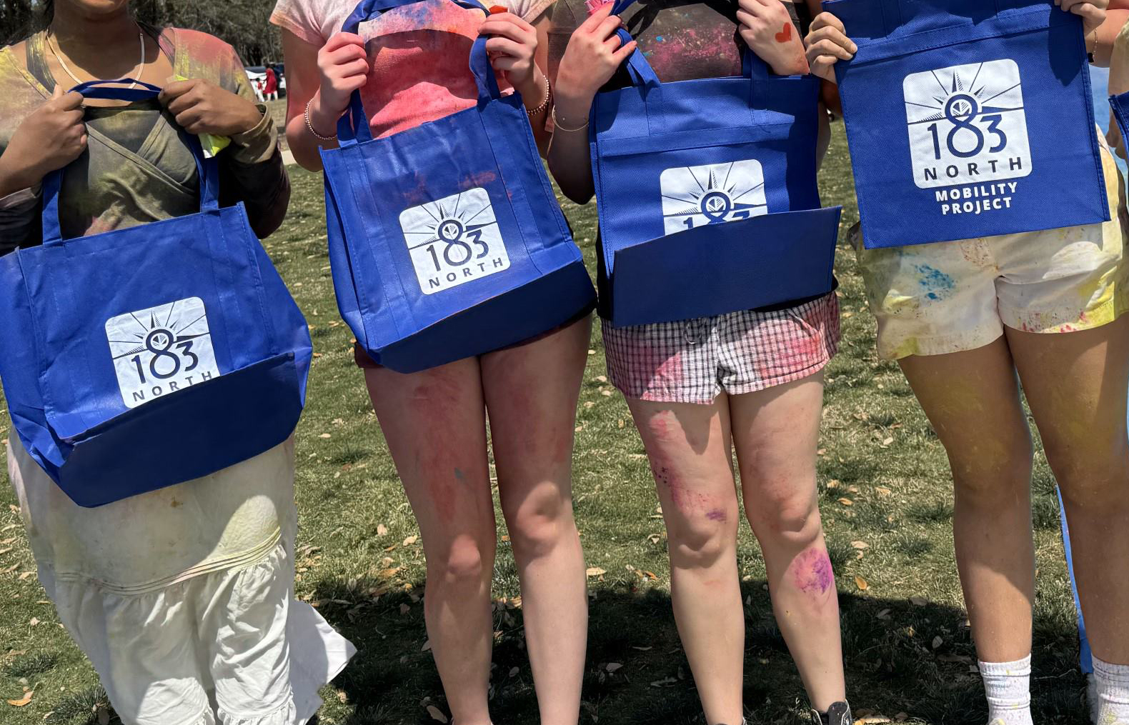 photo of reusable totes being held by group of women