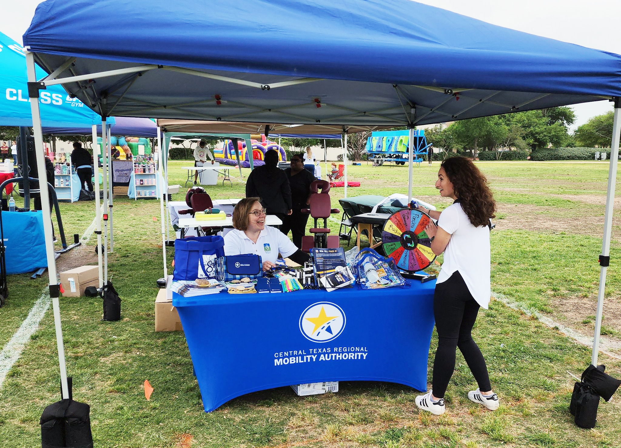 The 183 North and Mobility Authority teams at a table with branded promotional items.