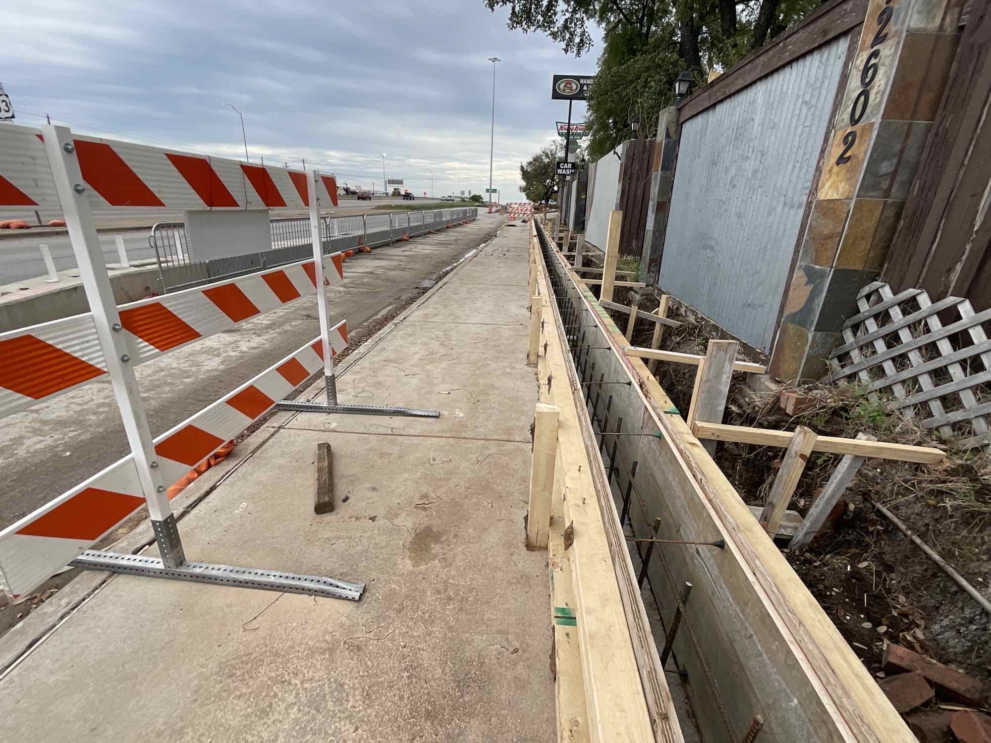 Completed sidewalk - Sidewalk wall being constructed on the 183 Southbound frontage road