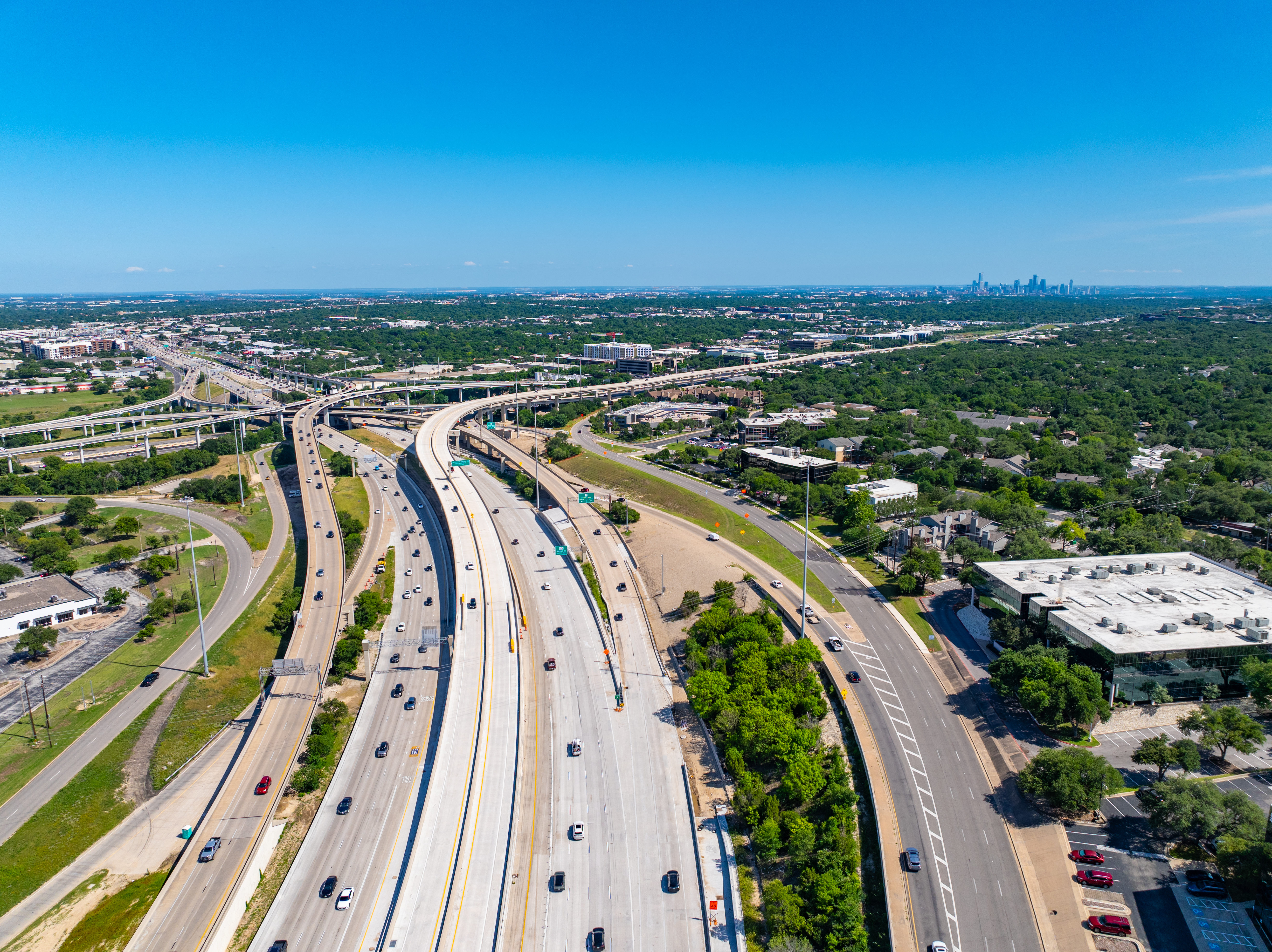 Aerial view of the US 183 and MoPac interchange, showing the southbound Frontage Road, direct connectors to southbound MoPac and the 183 Express Lanes, and northbound US 183 mainlines. 