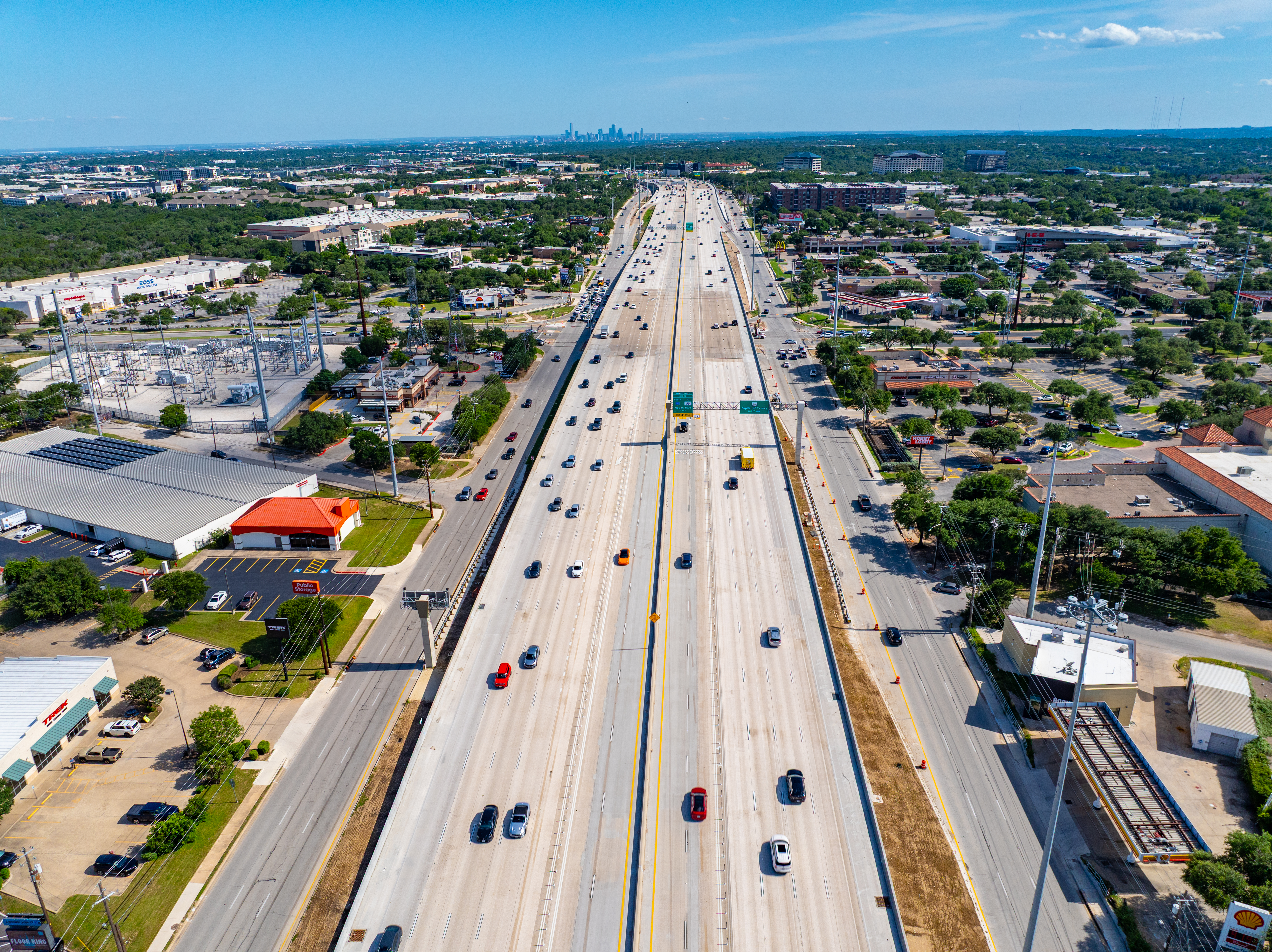 Aerial view of the 183 North Mobility Project near Ascension Seton Northwest Hospital, centered over the median separating the northbound and southbound express lanes. The image highlights the mainlanes and frontage roads in both directions.