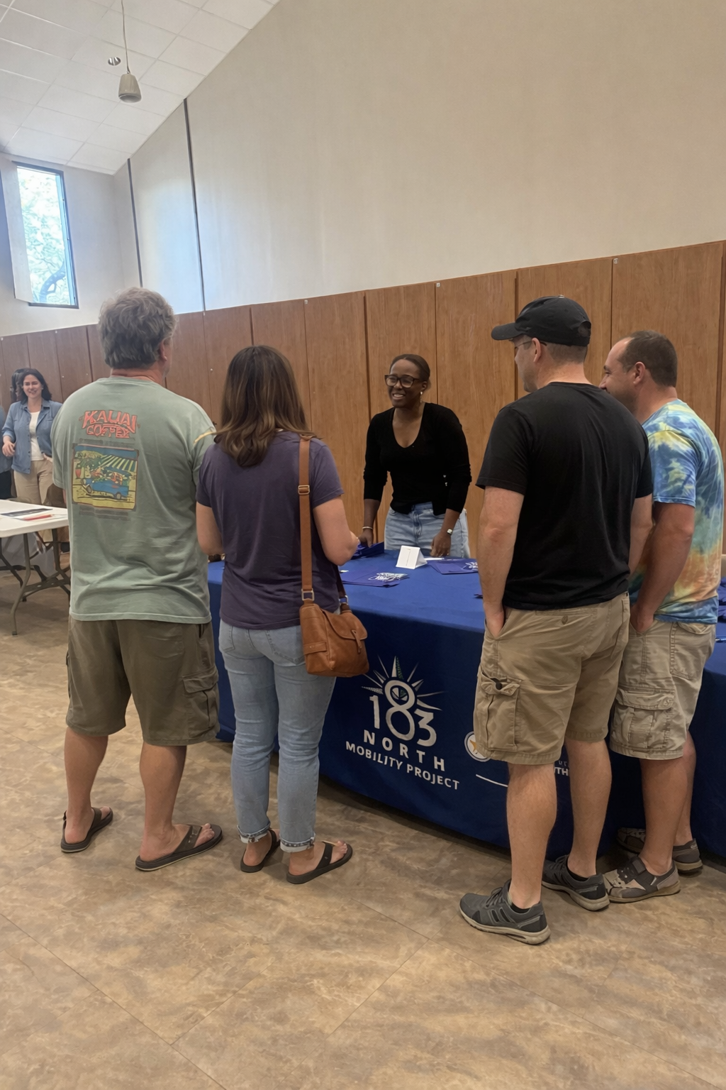 Attendees visit informational table and project representative
